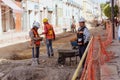 Construction workers repair a road in the Historic Center of Puebla