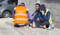 Construction workers resting on the street at lunchtime Royalty Free Stock Photo