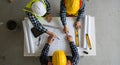 Construction Workers Reviewing Blueprint Plans on a Table Top View Royalty Free Stock Photo