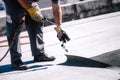 Construction workers, roofers installing rolls of bituminous waterproofing membrane for the waterproofing of new house. House Royalty Free Stock Photo