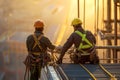 Construction workers in safety gear working at heights with fall arrestor devices for protection Royalty Free Stock Photo