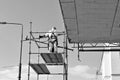 Construction workers on a scaffold. Black and white. Royalty Free Stock Photo