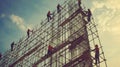 Construction Workers on Scaffolding Against a Cloudy Sky Royalty Free Stock Photo