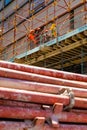 Construction workers on scaffolding on building site