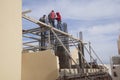 Construction workers setting rebar for a building