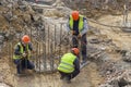 Construction workers setting steel rebar reinforcement