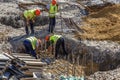 Construction workers setting steel rebars