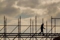 Construction workers silhouette working on iron platform sky background Royalty Free Stock Photo