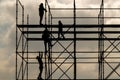 Construction workers silhouette working on iron platform sky background Royalty Free Stock Photo