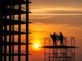 Construction workers silhouetted against sunset Royalty Free Stock Photo