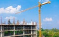 Construction workers site and building of housing at laborer work outdoor which has tower crane blue sky background with copy sp Royalty Free Stock Photo