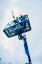 Construction workers on site in hydraulic lifting ramp Royalty Free Stock Photo