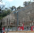 Construction workers structurally enhancing a cement wall cut into a mountain for a new building site in Mexico City Royalty Free Stock Photo