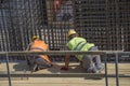 Construction workers tying rebar to make reinforcing frame 2
