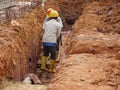 Construction workers are using the baby compactor to level and compact the soil at the construction site.