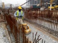 Construction workers are using the baby compactor to level and compact the soil at the construction site.