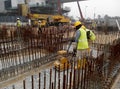 Construction workers are using the baby compactor to level and compact the soil at the construction site.