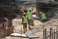 Construction workers are using the baby compactor to level and compact the soil at the construction site.