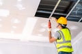 Construction workers using an electric drill are install the ceiling house in the building under construction, Ceiling Royalty Free Stock Photo