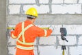 Construction workers Is using a laser level meter for wall leveling device