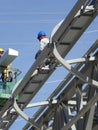 Construction workers using the mobile crane bucket Royalty Free Stock Photo