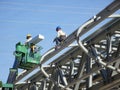 Construction workers using the mobile crane bucket Royalty Free Stock Photo