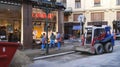 Construction workers and vehicles in the center of Prague repair roads and sidewalks.