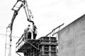 Construction workers on a scaffold. Black and white. Royalty Free Stock Photo