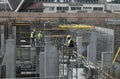 Construction site with reinforcement works before concrete pumping works. A group of three workers in work clothes Royalty Free Stock Photo