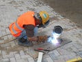 Construction workers welding pipes at the construction site.