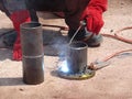 Construction workers welding pipes at the construction site. Royalty Free Stock Photo