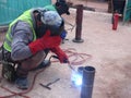 Construction workers welding pipes at the construction site.