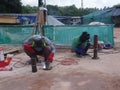 Construction workers welding pipes at the construction site. Royalty Free Stock Photo