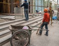 Construction workers with wheelbarrow, Shanghai, China