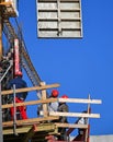 Construction workers at work next to a crane