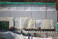 Construction workers working on a construction site with film-covered walls