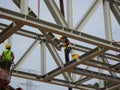 Construction workers working at height installing the steel structure.