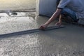 Construction workers are working by leveling the concrete floor. Royalty Free Stock Photo