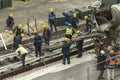 Tel Aviv, Israel - May 20 2021: Construction Workers working in the rain. Light rail tracks. blue collar worker. Concept