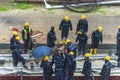 Tel Aviv, Israel - May 20 2021: Construction Workers working in the rain. Light rail tracks. blue collar worker. Concept