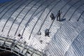 Construction workers working on the roof of a building tied with Royalty Free Stock Photo