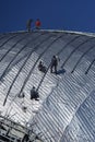 Construction workers working on the roof of a building tied with Royalty Free Stock Photo