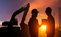 Construction workers working on a construction site at sunset for industry background Royalty Free Stock Photo