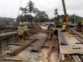 Construction workers working at the steel reinforcement bar bending yard in the construction site. Royalty Free Stock Photo