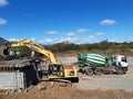 Construction works ongoing, worksite with workers and heavy machines.