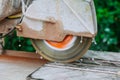 Construction works tiling with a circular saw a man sawing ceramic tiles worker sawing a tile Royalty Free Stock Photo