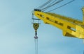 construction yellow crane jib against blue sky Royalty Free Stock Photo