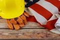 Construction yellow helmet and leather gloves on happy Labor Day USA patriotic a federal holiday of United States America Flag Royalty Free Stock Photo