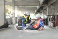 construction young worker having an accident steel falls over legs