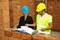 Constructions workers looking on house plans Royalty Free Stock Photo